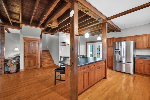 708 N 1950th Rd, Tonica, IL 61370 - kitchen with stainless steel refrigerator with ice dispenser, dark countertops, brown cabinets, and a wooden ceiling with exposed beams