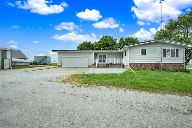 708 N 1950th Rd, Tonica, IL 61370 - view of front facade with concrete driveway, a garage, and a front yard