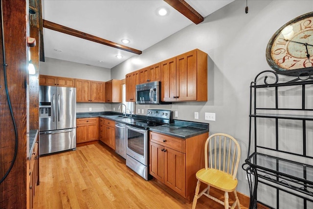 708 N 1950th Rd, Tonica, IL 61370 - kitchen with stainless steel appliances, beam ceiling, brown cabinetry, dark countertops, and light wood-style floors