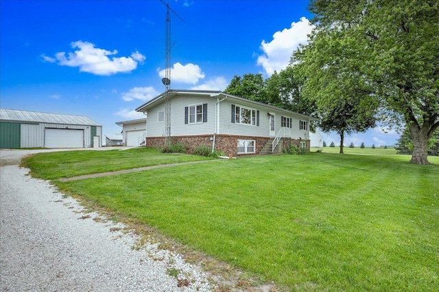 708 N 1950th Rd, Tonica, IL 61370 - view of home's exterior with a yard, a detached garage, brick siding, and driveway