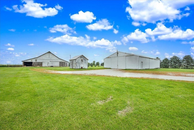 708 N 1950th Rd, Tonica, IL 61370 - view of green lawn featuring an outdoor structure, a barn, and an outbuilding