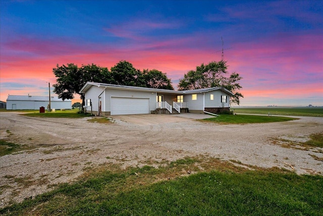 708 N 1950th Rd, Tonica, IL 61370 - ranch-style home with an attached garage, dirt driveway, and a front lawn