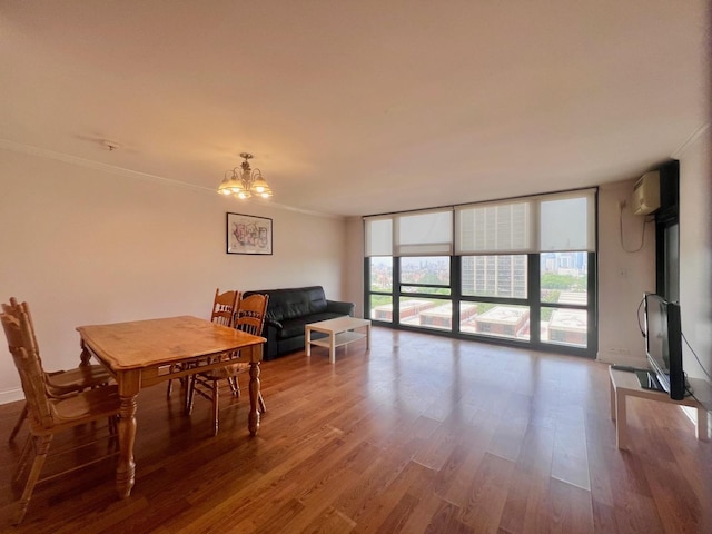 3001 S Michigan Ave Unit 909, Chicago, IL 60616 - dining space featuring a chandelier, an AC wall unit, wood finished floors, crown molding, and expansive windows