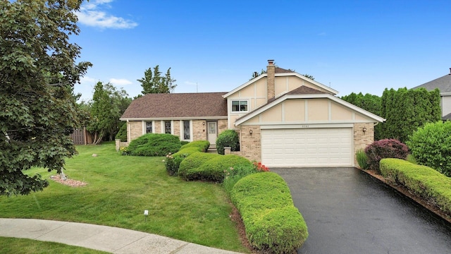 9242 Pembrooke Ln, Orland Park, IL 60462 - view of front facade with an attached garage, driveway, brick siding, a front yard, and a chimney
