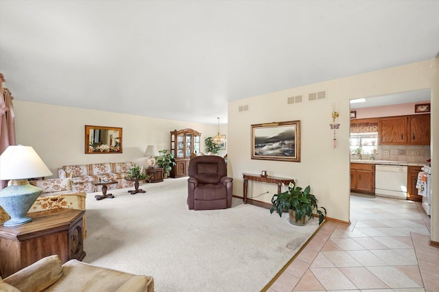 9242 Pembrooke Ln, Orland Park, IL 60462 - living area with light tile patterned flooring, a chandelier, and light colored carpet