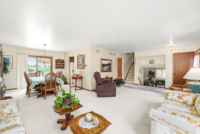 9242 Pembrooke Ln, Orland Park, IL 60462 - living area featuring stairway, light colored carpet, and a chandelier