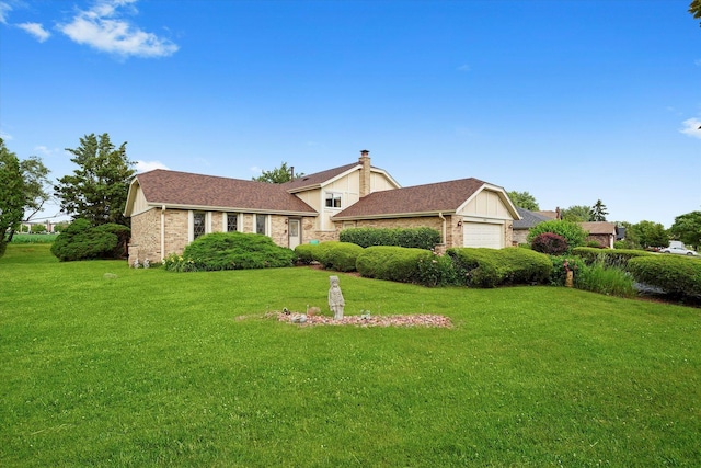 9242 Pembrooke Ln, Orland Park, IL 60462 - tri-level home with a garage, a front lawn, brick siding, and a chimney