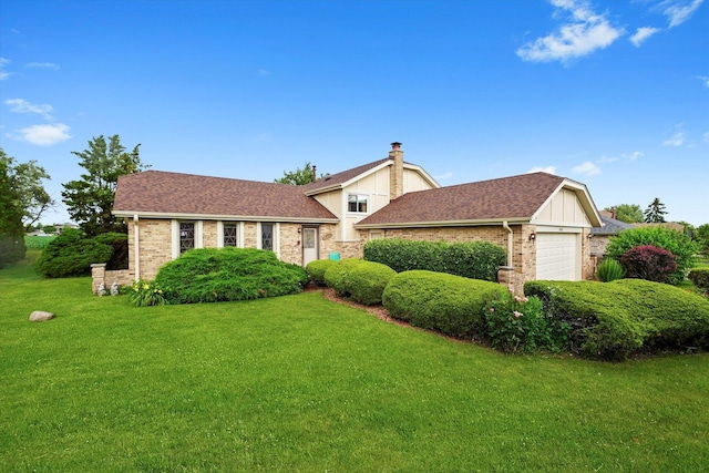 9242 Pembrooke Ln, Orland Park, IL 60462 - split level home featuring an attached garage, a front yard, brick siding, a chimney, and roof with shingles