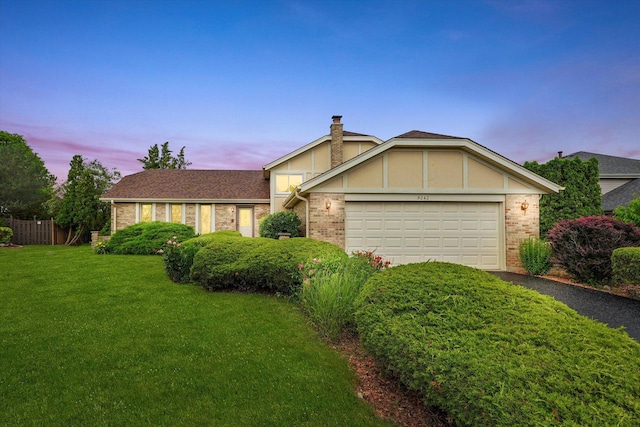 9242 Pembrooke Ln, Orland Park, IL 60462 - view of front of house with brick siding, an attached garage, a chimney, and driveway