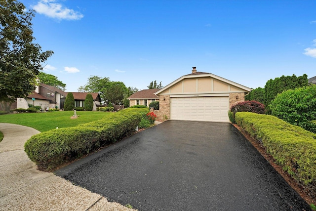 9242 Pembrooke Ln, Orland Park, IL 60462 - view of front of property with driveway, an attached garage, brick siding, a front yard, and a residential view