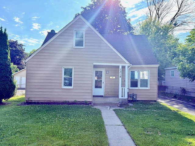 1318 Pine Grove Ave, Round Lake Beach, IL 60073 - bungalow-style home featuring a front yard and a porch