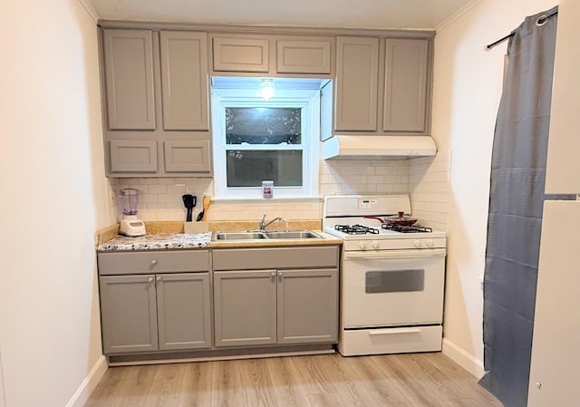 1318 Pine Grove Ave, Round Lake Beach, IL 60073 - kitchen featuring gray cabinets, white range with gas stovetop, custom exhaust hood, and light wood-style flooring