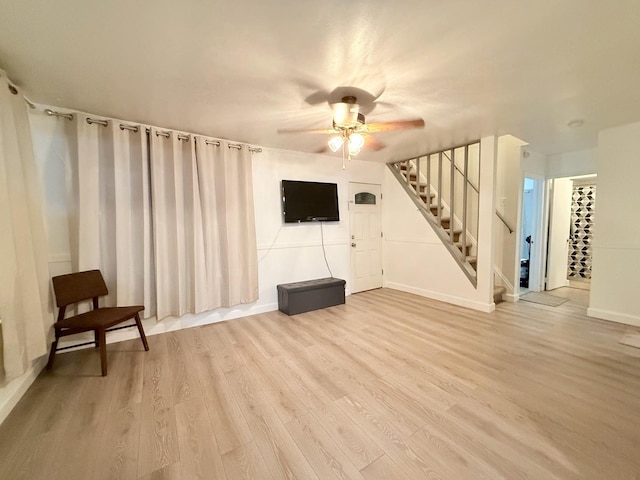 1318 Pine Grove Ave, Round Lake Beach, IL 60073 - unfurnished living room with stairs, ceiling fan, and wood finished floors