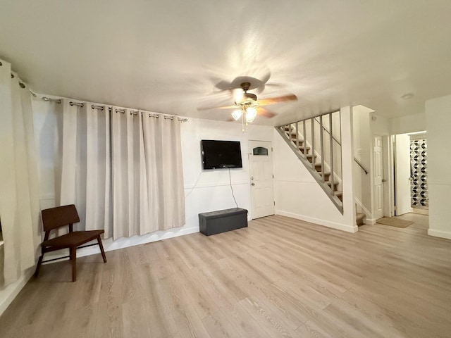 1318 Pine Grove Ave, Round Lake Beach, IL 60073 - unfurnished living room with stairs, ceiling fan, and light wood finished floors