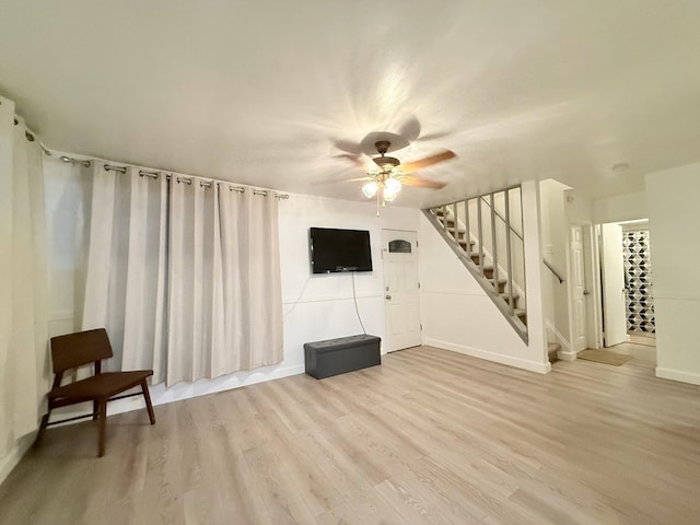 1318 Pine Grove Ave, Round Lake Beach, IL 60073 - unfurnished living room featuring stairway, ceiling fan, and light wood-style floors