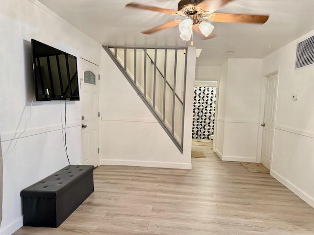 1318 Pine Grove Ave, Round Lake Beach, IL 60073 - unfurnished living room featuring a ceiling fan, light wood-type flooring, and stairs