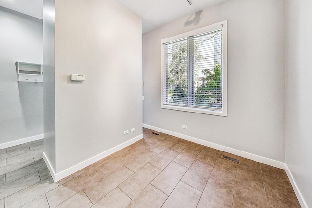 1223 W Cottage Pl, Chicago, IL 60607 - spare room with baseboards and light tile patterned floors