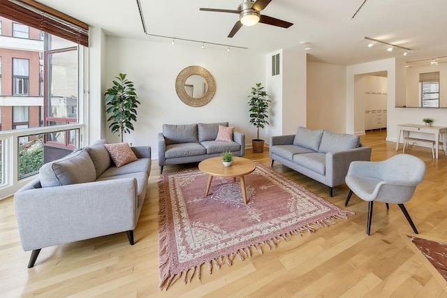 1223 W Cottage Pl, Chicago, IL 60607 - living room with rail lighting, light wood finished floors, ceiling fan, and healthy amount of natural light