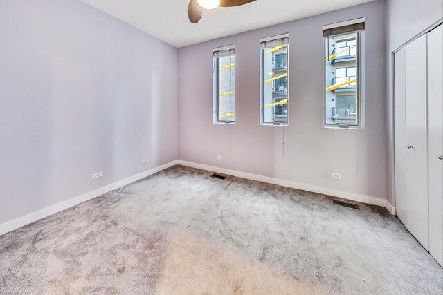 1223 W Cottage Pl, Chicago, IL 60607 - unfurnished bedroom featuring carpet, multiple windows, a closet, and ceiling fan