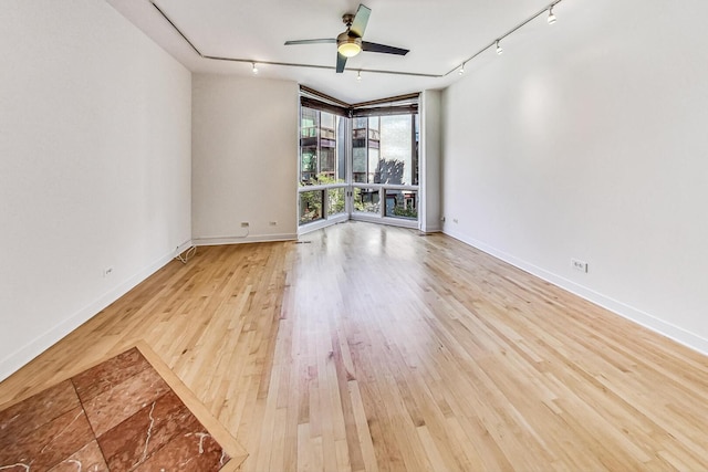 1223 W Cottage Pl, Chicago, IL 60607 - spare room featuring rail lighting, light wood finished floors, and a ceiling fan