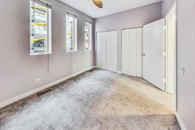1223 W Cottage Pl, Chicago, IL 60607 - unfurnished bedroom featuring multiple closets, carpet floors, and ceiling fan