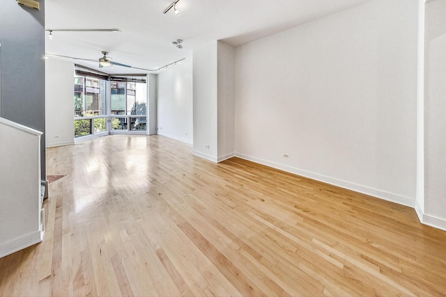 1223 W Cottage Pl, Chicago, IL 60607 - spare room with light wood finished floors, rail lighting, and ceiling fan