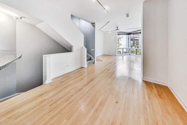 1223 W Cottage Pl, Chicago, IL 60607 - spare room with ceiling fan, wood finished floors, track lighting, and stairs