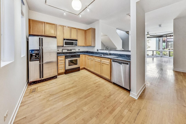 1223 W Cottage Pl, Chicago, IL 60607 - kitchen featuring appliances with stainless steel finishes, dark countertops, light wood-style flooring, and light brown cabinetry