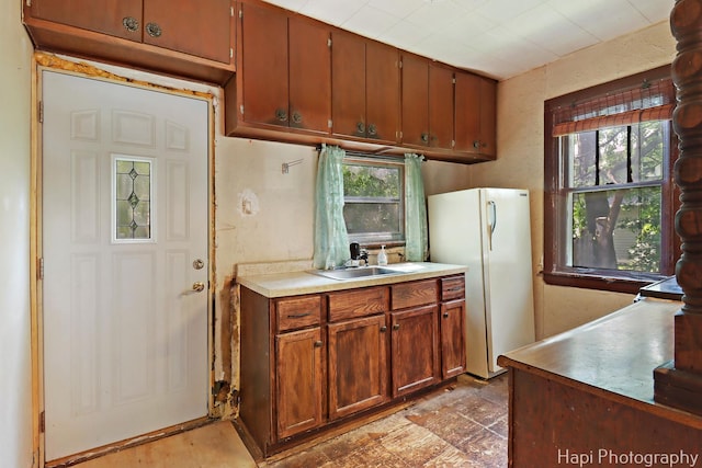 35835 N Ash St, Ingleside, IL 60041 - kitchen with freestanding refrigerator, plenty of natural light, light countertops, and brown cabinetry