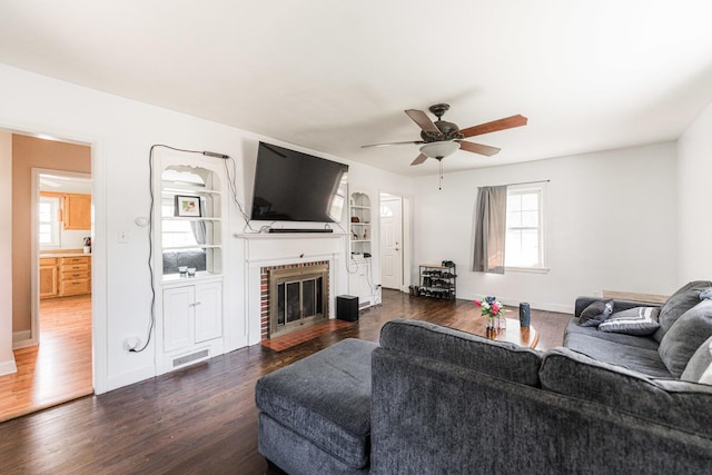 1020 N 8th St, Rochelle, IL 61068 - living area with dark wood-type flooring, a ceiling fan, and a fireplace