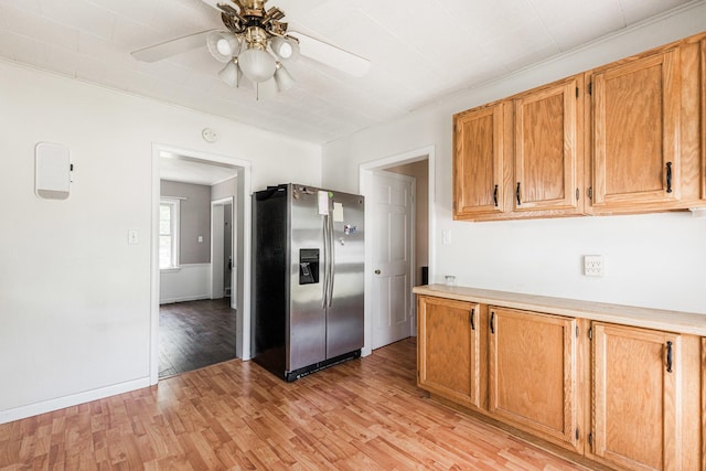1020 N 8th St, Rochelle, IL 61068 - kitchen with stainless steel fridge with ice dispenser, ceiling fan, light wood-type flooring, light countertops, and brown cabinetry