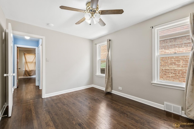 7220 S Spaulding Ave, Chicago, IL 60629 - empty room featuring dark wood-type flooring, a ceiling fan, and a smoke detector