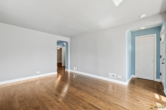 7220 S Spaulding Ave, Chicago, IL 60629 - spare room featuring arched walkways and wood finished floors