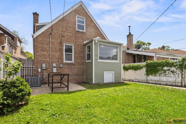 7220 S Spaulding Ave, Chicago, IL 60629 - rear view of house featuring brick siding, a patio area, and a chimney