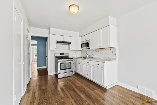 7220 S Spaulding Ave, Chicago, IL 60629 - kitchen with stainless steel appliances, under cabinet range hood, light countertops, and white cabinets