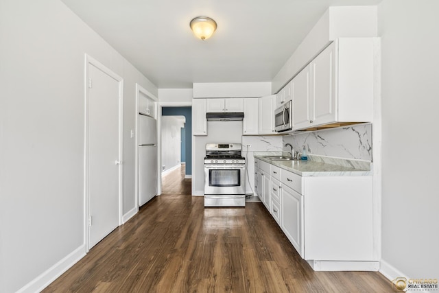 7220 S Spaulding Ave, Chicago, IL 60629 - kitchen featuring appliances with stainless steel finishes, light countertops, under cabinet range hood, and dark wood finished floors