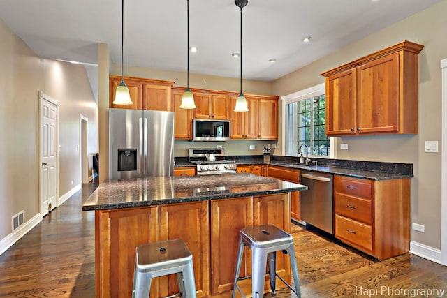 1340 Park Ave, Winthrop Harbor, IL 60096 - kitchen featuring stainless steel appliances, dark wood-style floors, a center island, brown cabinets, and recessed lighting