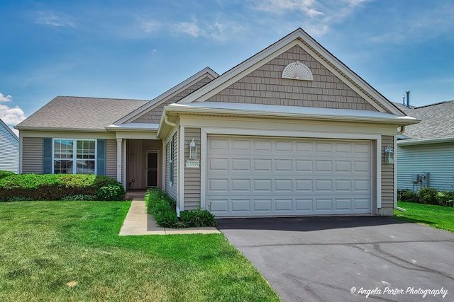13399 Glenwood Dr, Huntley, IL 60142 - single story home with a front yard, asphalt driveway, and an attached garage