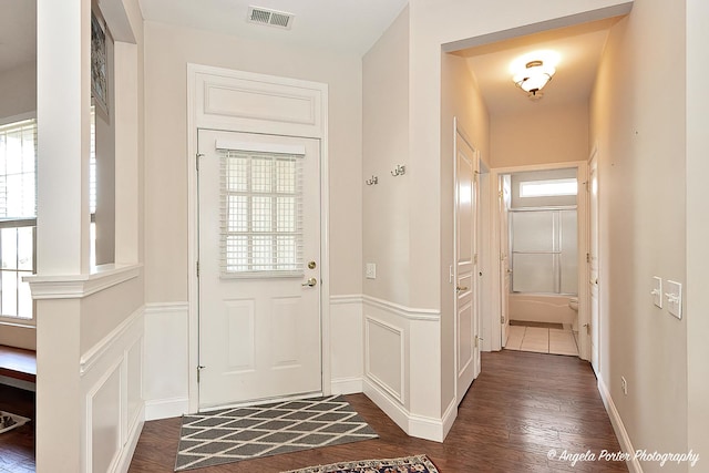 13399 Glenwood Dr, Huntley, IL 60142 - foyer featuring wainscoting, dark wood-style flooring, and a decorative wall