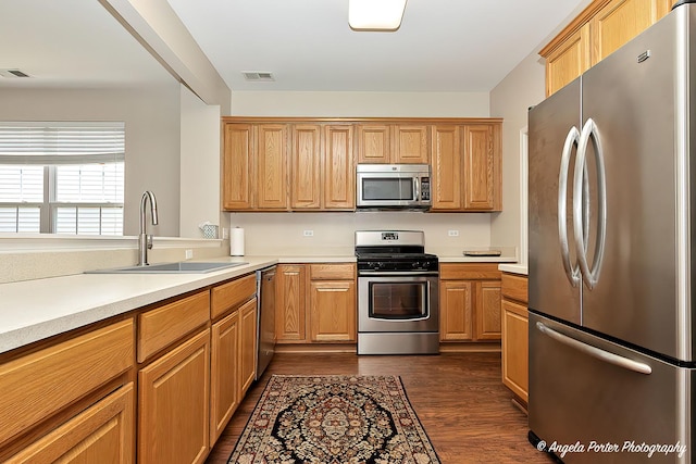 13399 Glenwood Dr, Huntley, IL 60142 - kitchen with appliances with stainless steel finishes, dark wood-type flooring, and light countertops