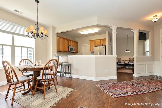 13399 Glenwood Dr, Huntley, IL 60142 - dining room with healthy amount of natural light, dark wood-style flooring, and a chandelier