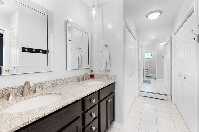 1060 Highland Ave, Lake Forest, IL 60045 - full bath featuring a baseboard radiator, tile patterned floors, double vanity, and a closet
