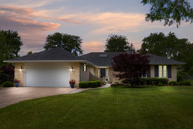 1060 Highland Ave, Lake Forest, IL 60045 - view of front facade with an attached garage, concrete driveway, brick siding, and roof with shingles