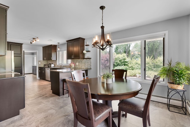 1060 Highland Ave, Lake Forest, IL 60045 - dining space with a chandelier, a baseboard radiator, and rail lighting