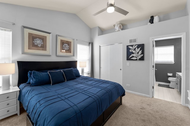 1361 Amherst Ct, Grayslake, IL 60030 - bedroom with a closet, vaulted ceiling, light carpet, connected bathroom, and a ceiling fan