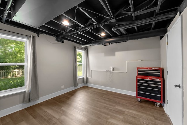 1361 Amherst Ct, Grayslake, IL 60030 - basement with healthy amount of natural light, wood finished floors, and heating unit