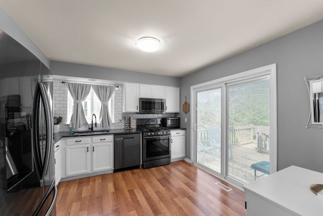 1361 Amherst Ct, Grayslake, IL 60030 - kitchen featuring dishwasher, refrigerator with ice dispenser, stainless steel microwave, range with gas cooktop, and decorative backsplash