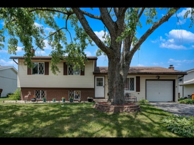 5112 Deerpath Rd, Oak Forest, IL 60452 - split level home with driveway, an attached garage, a front lawn, and brick siding
