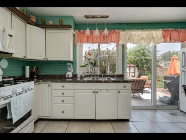 5112 Deerpath Rd, Oak Forest, IL 60452 - kitchen featuring white appliances, white cabinetry, light tile patterned flooring, hanging light fixtures, and decorative backsplash