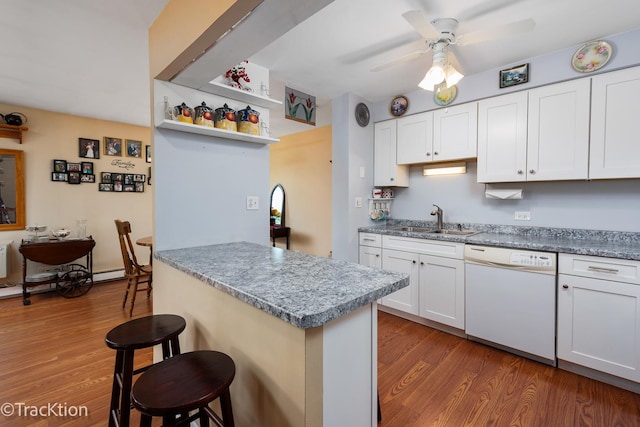 1056 N Mill St Unit 305, Naperville, IL 60563 - kitchen with white dishwasher, a breakfast bar, wood finished floors, and a ceiling fan